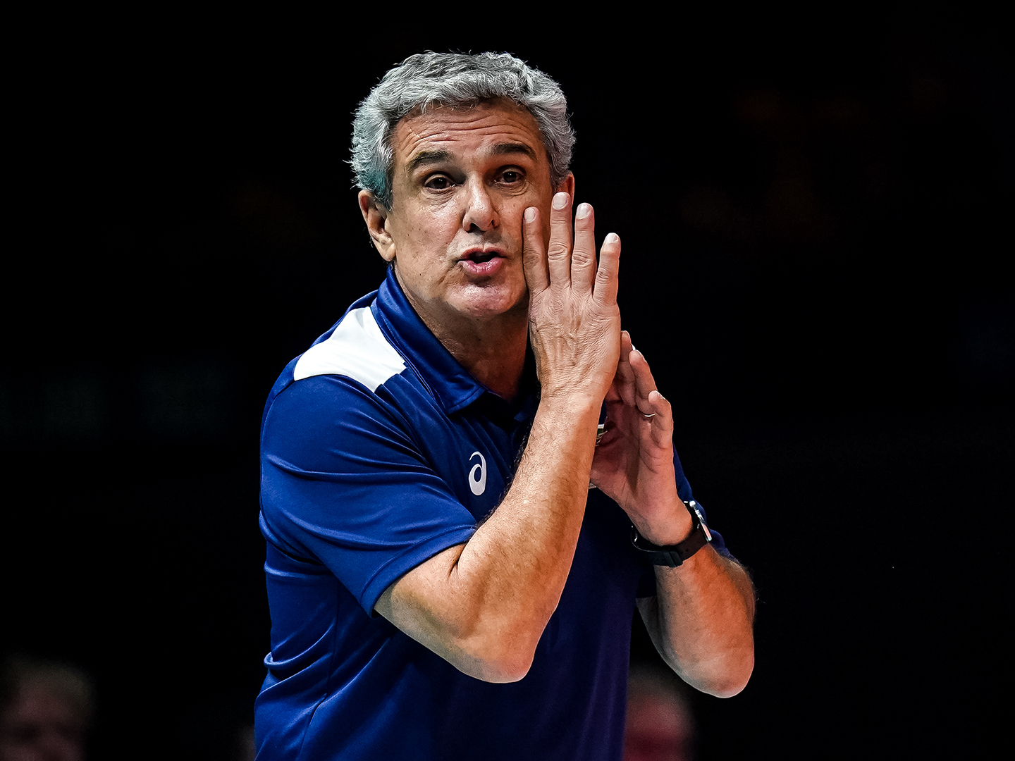 José Roberto “Zé Roberto” Guimarães pumps his fists and yells in excitement